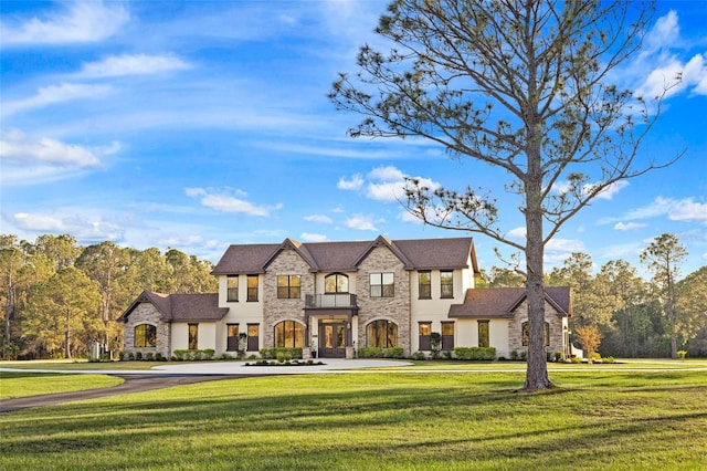 5500 State Road 33, Clermont, FL 34714 - french provincial home with a front yard, stone siding, and stucco siding