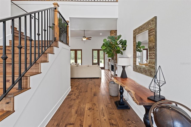 5500 State Road 33, Clermont, FL 34714 - entrance foyer with baseboards, a ceiling fan, a towering ceiling, stairway, and hardwood / wood-style floors