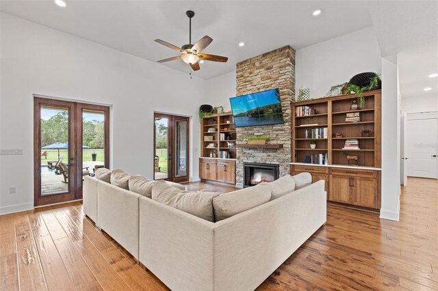 5500 State Road 33, Clermont, FL 34714 - living area featuring baseboards, light wood-style flooring, a high ceiling, a fireplace, and recessed lighting