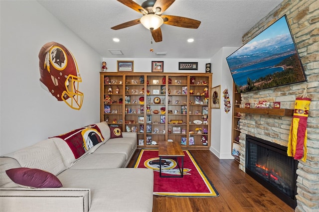 5500 State Road 33, Clermont, FL 34714 - living area with a large fireplace, ceiling fan, a textured ceiling, and wood finished floors