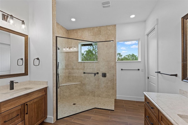 5500 State Road 33, Clermont, FL 34714 - bathroom with two vanities, visible vents, wood tiled floor, a sink, and tiled shower