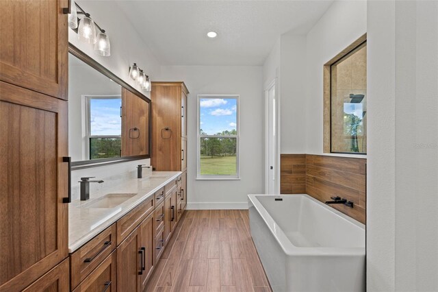 5500 State Road 33, Clermont, FL 34714 - full bathroom featuring double vanity, a soaking tub, a sink, and wood finished floors