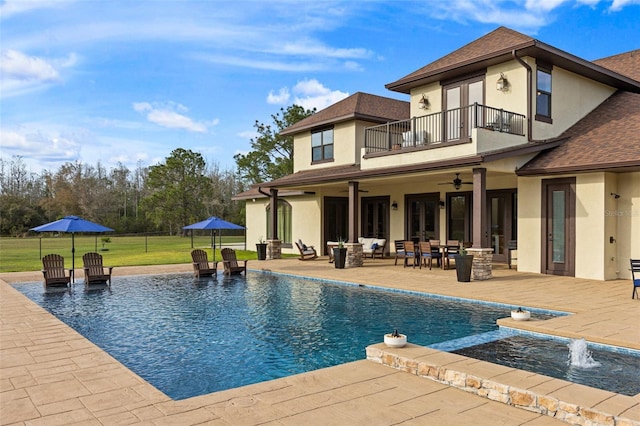 5500 State Road 33, Clermont, FL 34714 - back of property featuring a lawn, a balcony, ceiling fan, a patio area, and stucco siding