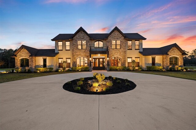 5500 State Road 33, Clermont, FL 34714 - french country style house featuring french doors, curved driveway, and a balcony