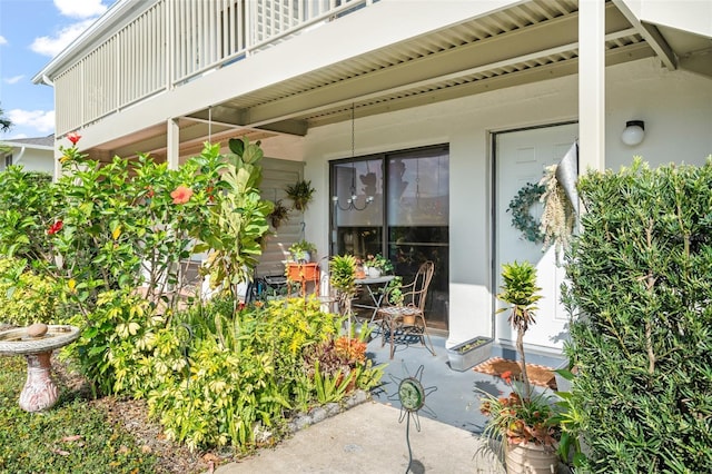 doorway to property featuring a patio and a balcony