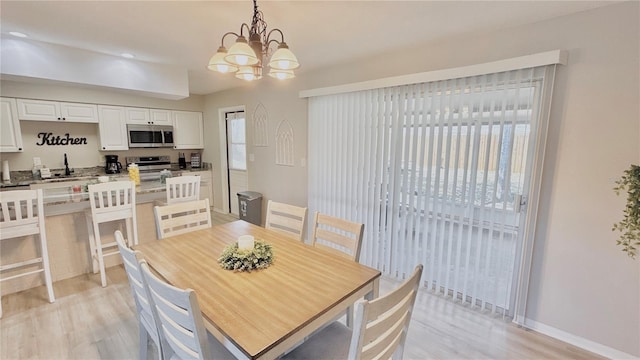 1420 Continental Dr, Daytona Beach, FL 32117 - dining room with light wood-style floors, a chandelier, baseboards, and recessed lighting