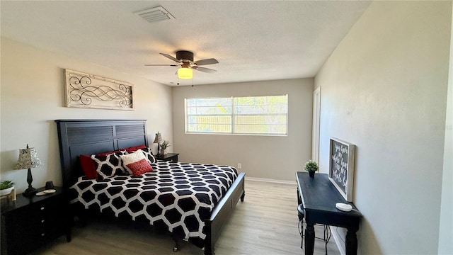 1420 Continental Dr, Daytona Beach, FL 32117 - bedroom featuring wood finished floors, a ceiling fan, and baseboards