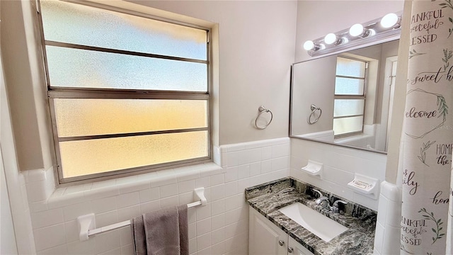 1420 Continental Dr, Daytona Beach, FL 32117 - bathroom featuring tile walls, a wainscoted wall, and vanity