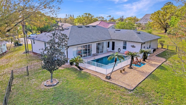 view of swimming pool featuring a yard, a fenced backyard, and a patio