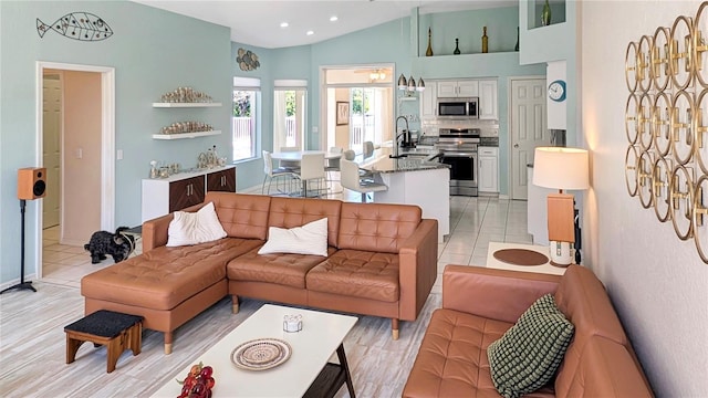 living area featuring vaulted ceiling, light tile patterned floors, and recessed lighting