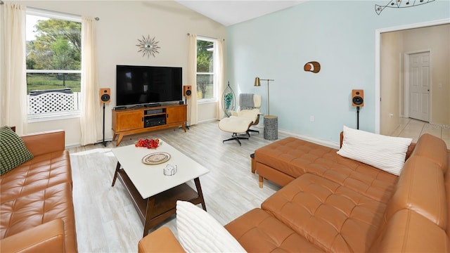 living area with light wood-style flooring, baseboards, and vaulted ceiling