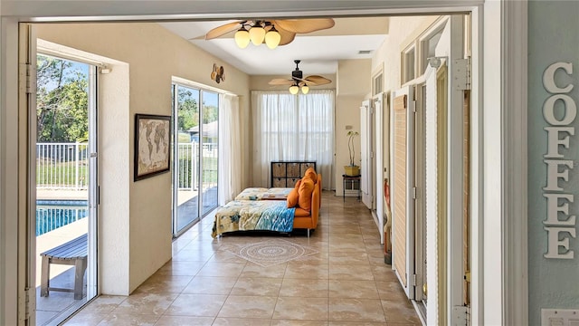 sitting room featuring light tile patterned floors and ceiling fan