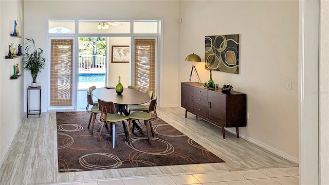 dining space with baseboards and wood finished floors