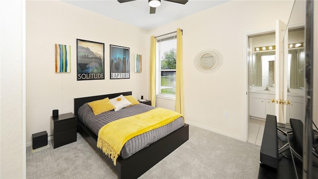 bedroom with baseboards, carpet, ensuite bath, a ceiling fan, and a sink