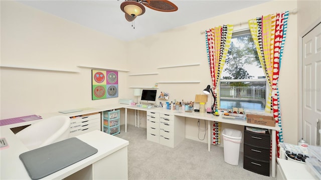 office space featuring a ceiling fan and light colored carpet