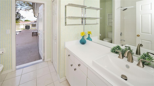 full bath with tile patterned floors, toilet, and wallpapered walls