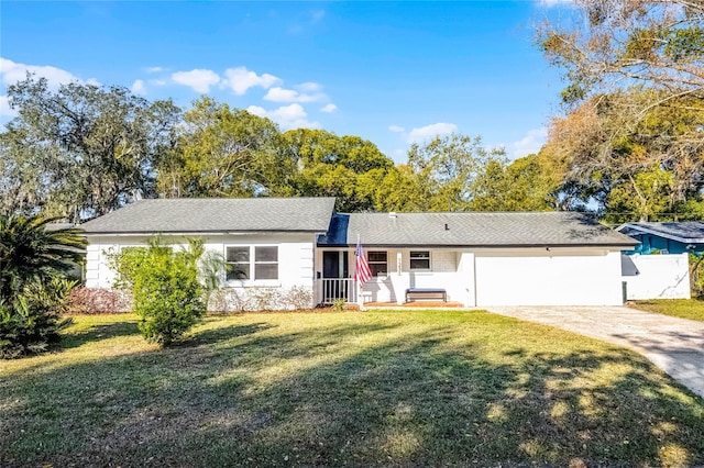 ranch-style house featuring a garage, driveway, and a front yard