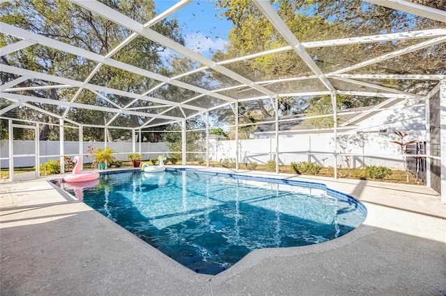 view of pool featuring a fenced in pool, glass enclosure, a fenced backyard, and a patio