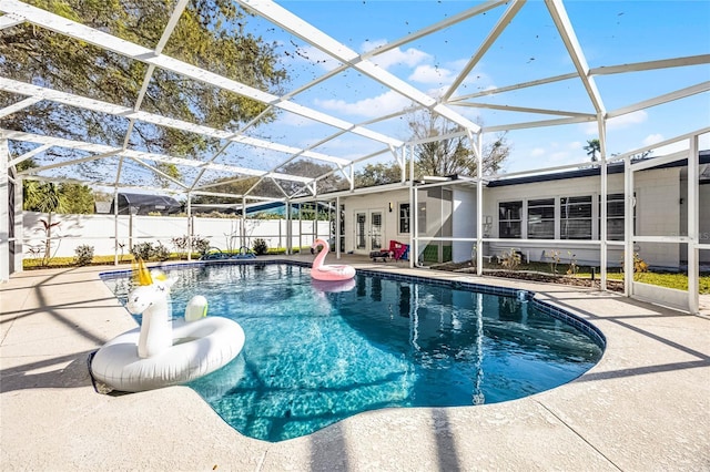 view of swimming pool featuring a fenced in pool, french doors, a patio area, and fence