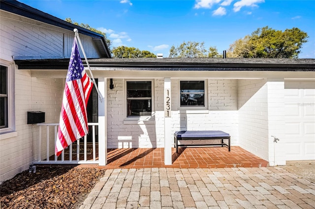 entrance to property featuring brick siding