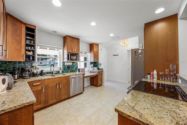 kitchen featuring stainless steel appliances, brown cabinetry, a sink, and backsplash