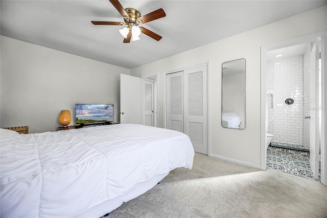 bedroom with baseboards, ensuite bath, ceiling fan, carpet, and a closet