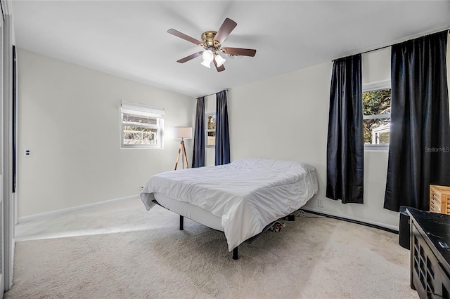 bedroom featuring carpet floors, baseboards, and a ceiling fan