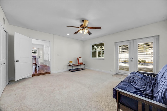 sitting room with ceiling fan, recessed lighting, light carpet, baseboards, and french doors