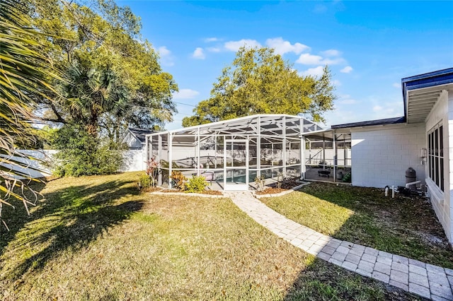 view of yard with a patio area, a lanai, a pool, and fence