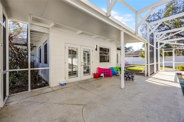 view of patio / terrace with french doors, fence, and a lanai