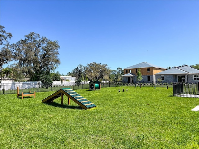 view of community with a yard and fence