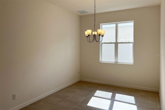 tiled empty room with baseboards and a chandelier