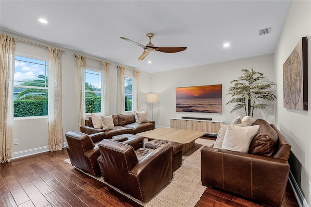 living area featuring a ceiling fan, baseboards, visible vents, dark wood finished floors, and recessed lighting