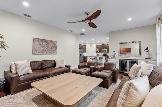 living area featuring recessed lighting, visible vents, beverage cooler, and a ceiling fan