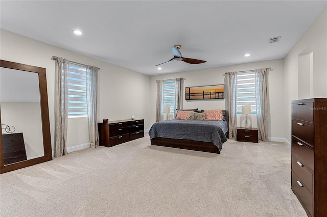 bedroom with recessed lighting, light colored carpet, baseboards, and ceiling fan