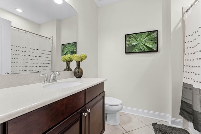 full bathroom featuring baseboards, toilet, vanity, and tile patterned flooring