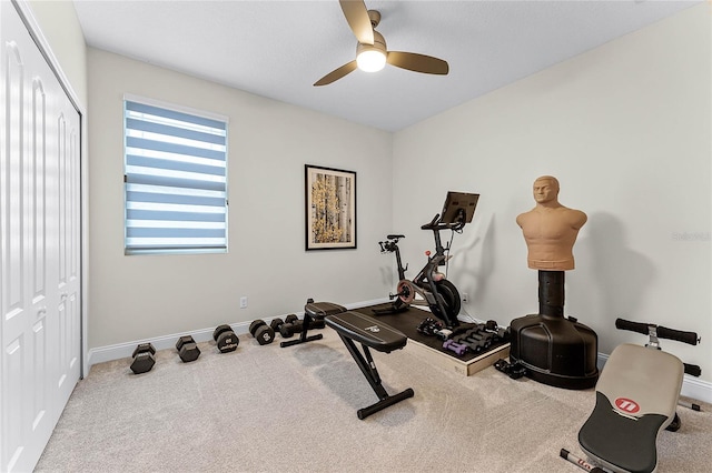 exercise room featuring carpet, baseboards, and ceiling fan