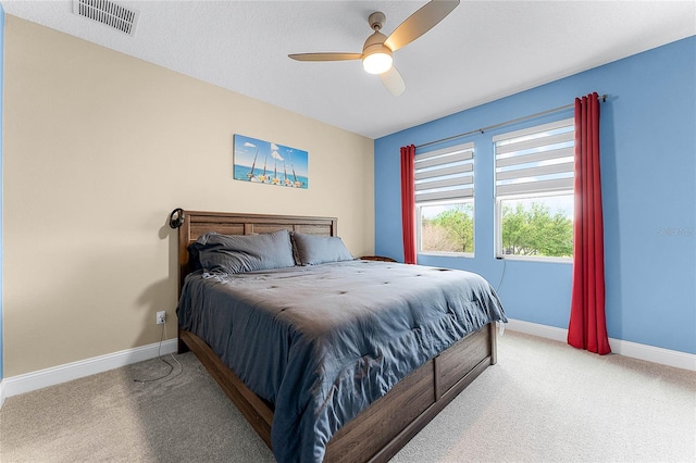 bedroom featuring a ceiling fan, carpet, visible vents, and baseboards