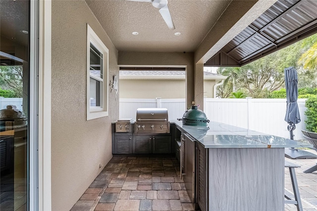 view of patio / terrace with a grill, ceiling fan, and fence