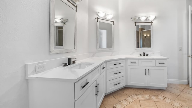 full bath featuring tile patterned floors, double vanity, and a sink