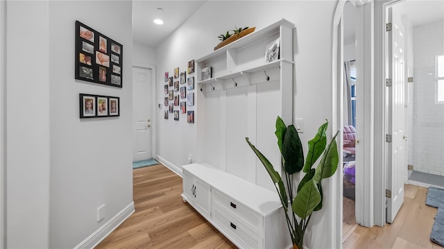 mudroom with recessed lighting, light wood-style floors, and baseboards