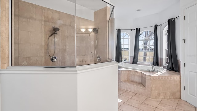 bathroom featuring a bath, tile patterned flooring, and a walk in shower