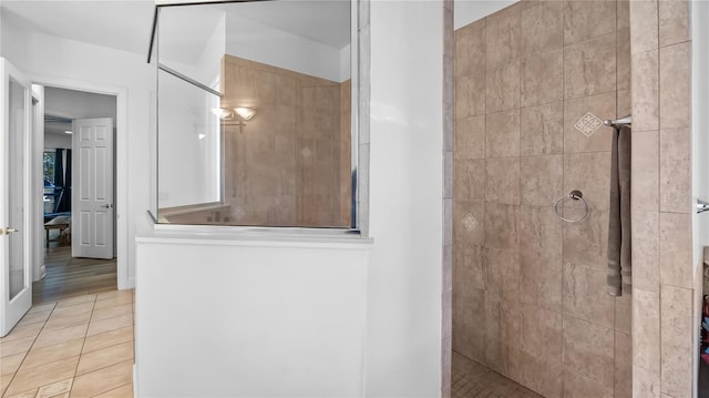 bathroom featuring tile patterned flooring and a walk in shower