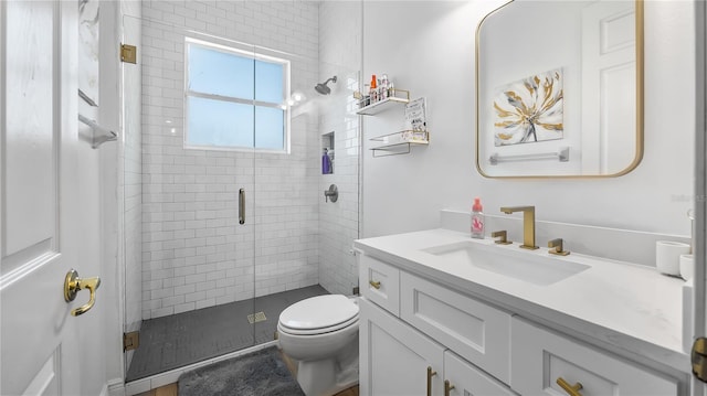 full bathroom with vanity, a shower stall, and toilet