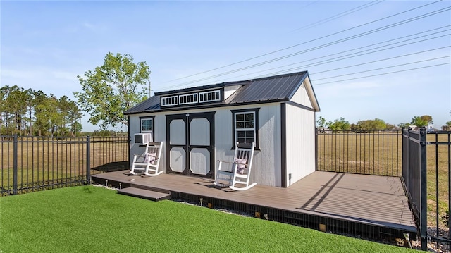 view of outdoor structure featuring an outbuilding and a fenced backyard