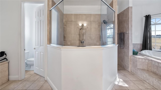 bathroom with a walk in shower, toilet, a bath, and tile patterned flooring