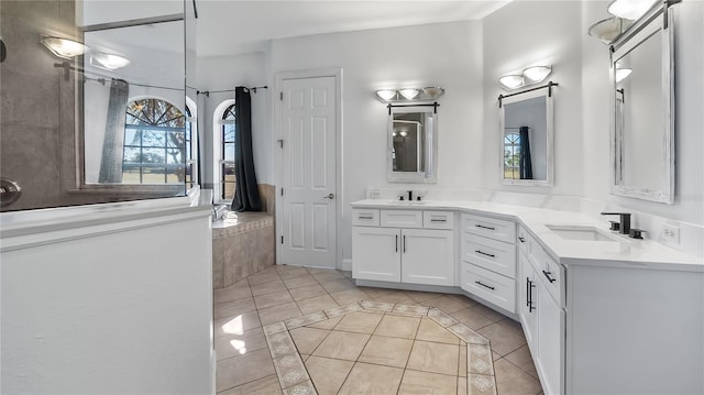 full bathroom with tile patterned floors, double vanity, and a sink