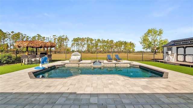 view of pool with an outdoor structure, a fenced in pool, a fenced backyard, and a patio area