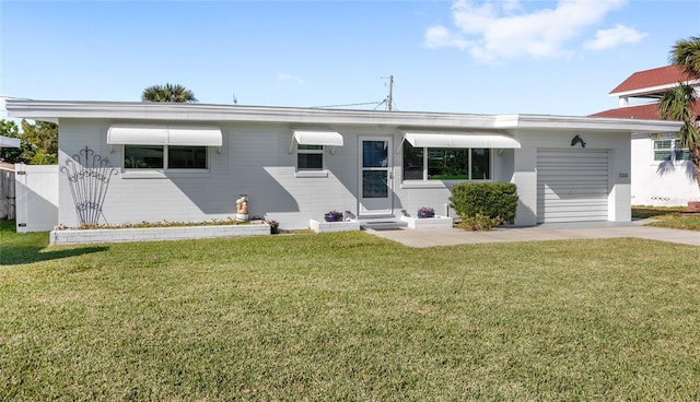 single story home with entry steps, a front lawn, and an attached garage