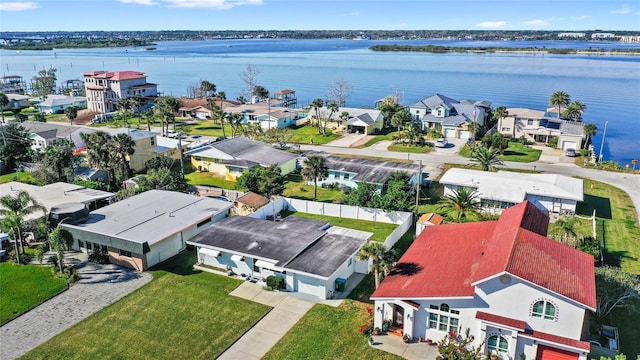 drone / aerial view featuring a water view and a residential view